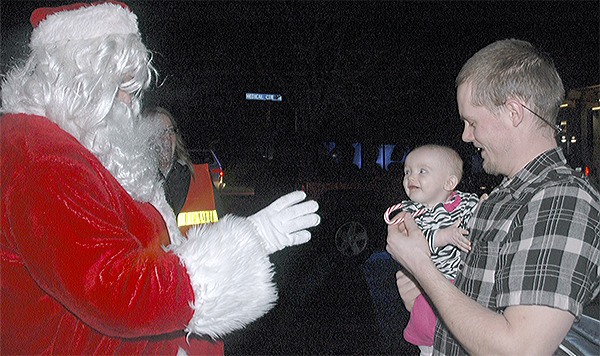 Santa greets little Korraline and her father