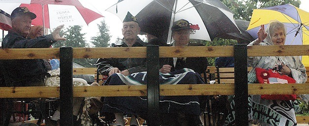 Arlington's surviving World War II and Korean War veterans wave to the crowds lining Olympic Avenue during this year's Memorial Day parade.