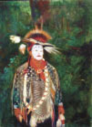 “Ghost Face” by Bezalel-Levy portrays a participant in The Festival of the River pow-wow sponsored by the Stillaguamish Tribe. He is wearing the traditional ghost face of a ghost dancer. The painting is part of a show. “They are the Hosts