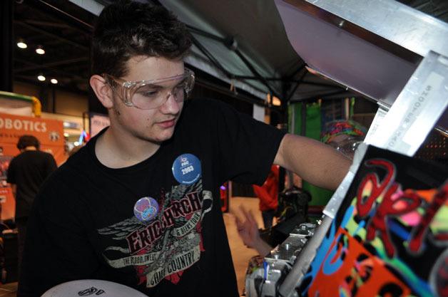 Cody Weldon works on Arlington High School’s competition robot at CenturyLink Field in Seattle on March 28.