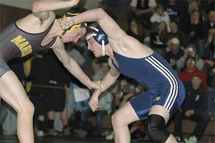 Dustin Ward locks arms with opponent Alex Coffman in the 152-pound match for the regional title.