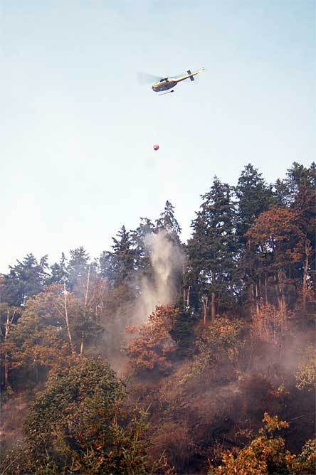 The Snohomish County Sheriff's Office provides air support to keep a brushfire contained near Lakewood on Wednesday