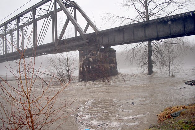 The Stillaguamish River reached 17 feet by 8:30 a.m. and passed flood stage 4 at 19 feet around noon. The very full and rapidly moving river carried logs and debris under Haller Bridge in Arlington Jan. 7.