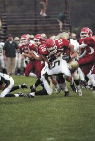 Junior running back Austin Denton is tackled in his four-touchdown effort in the non-conference meeting with Shorecrest.