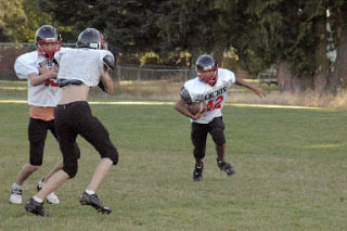 Running back Jordan Avery breaks left during an afternoon practice.