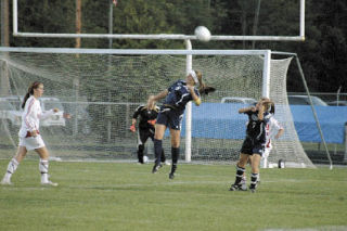 Arlington midfielder Kristen Allen fights for the ball in the air. The senior had the assist on Arlington’s game-winning goal as the Eagles improved to 1-1.