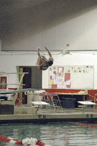 Senior diver Liz Kuljis executes a turn in one of her six dives against Meadowdale.