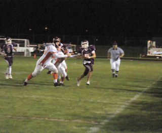 Senior wide receiver Jordan Stauffer tries to avoid Granite Falls defenders.