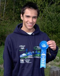 Arlington’s John Decker proudly shows off the first-place ribbon that he received for his age category at the Tacoma City Marathon on May 1.