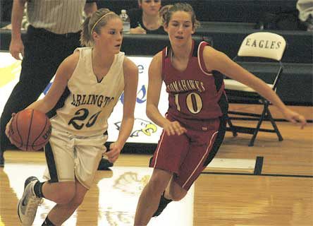 Eagles guard Quinn Kesselring brings the ball upcourt past a Tomahawks defender.