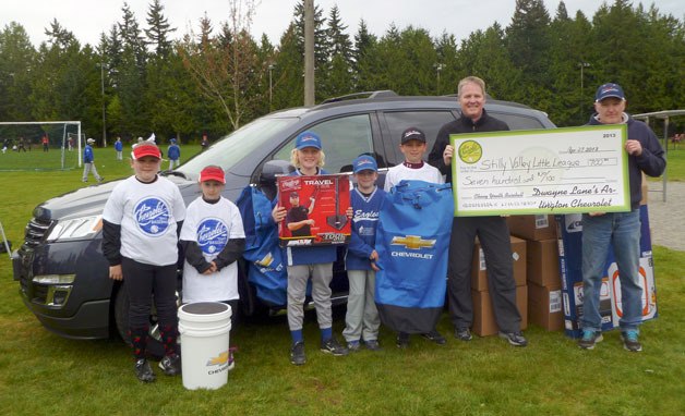 Players from Stilly Valley Little League show off shirts and equipment donated by Chevrolet