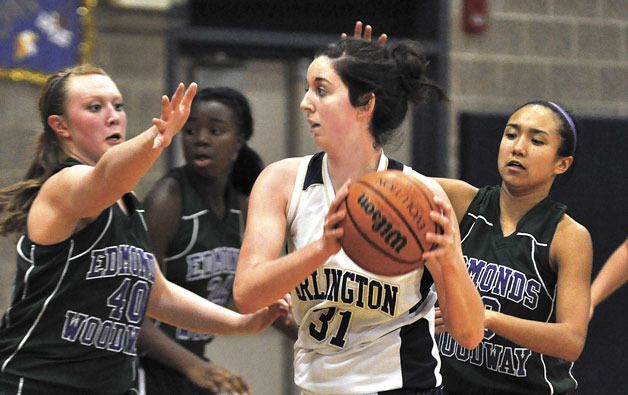 Arlington post Kaiti Ferro looks for help when a pair of Edmonds-Woodway defenders trap her