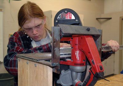 Arlington High School Robotics Team member Robert Haynes makes use of the school’s metal-shop to help fabricate the structure of this year’s competition robot.