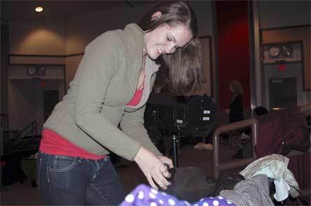 Lakewood High School student Karen Christiansen looks at costume items during a rehearsal for the play “The Mousetrap