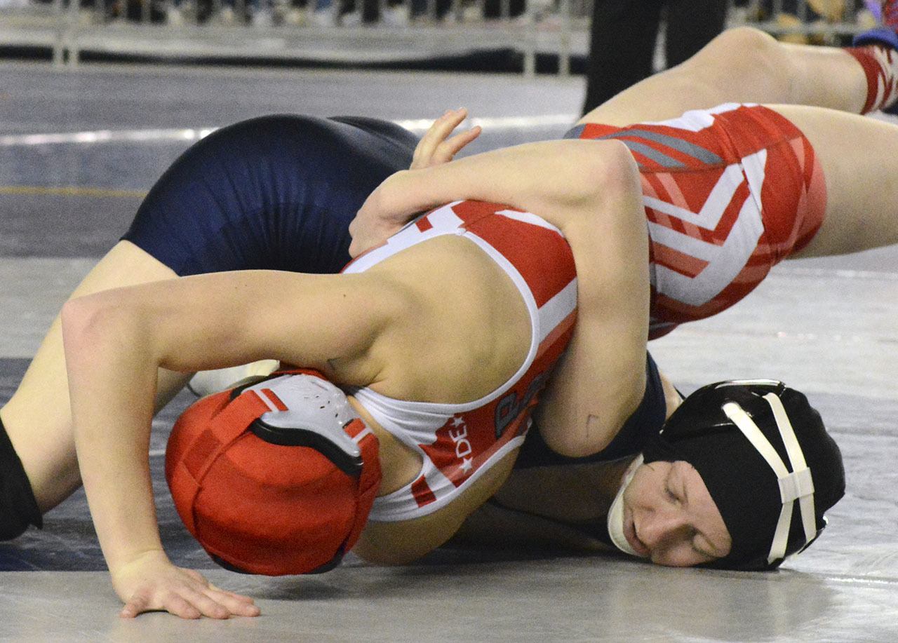 Arlington’s Jordynn Mani works for a pin during her first-round match at the girls state wrestling tournament. Brandon Adam/Staff Photo