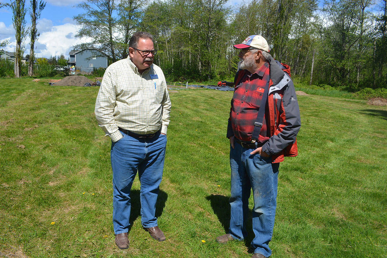 Dave Porter and Dean Smith talk at the site of where Sunnyside Village will be built.